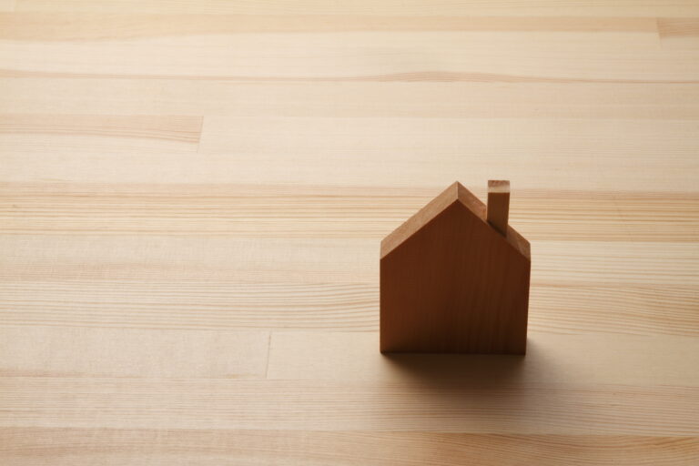 Wooden floor with a small wooden house on it